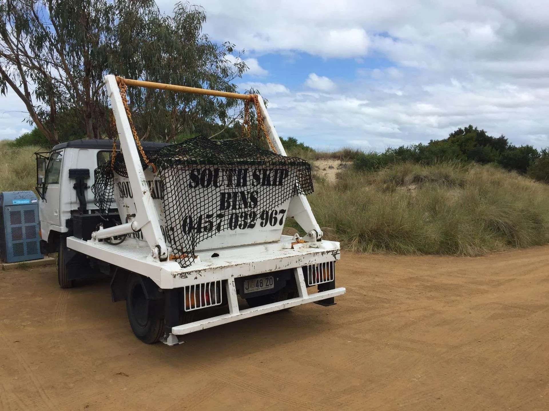 Green waste skip bin being lifted by a South Skip Bins truck
